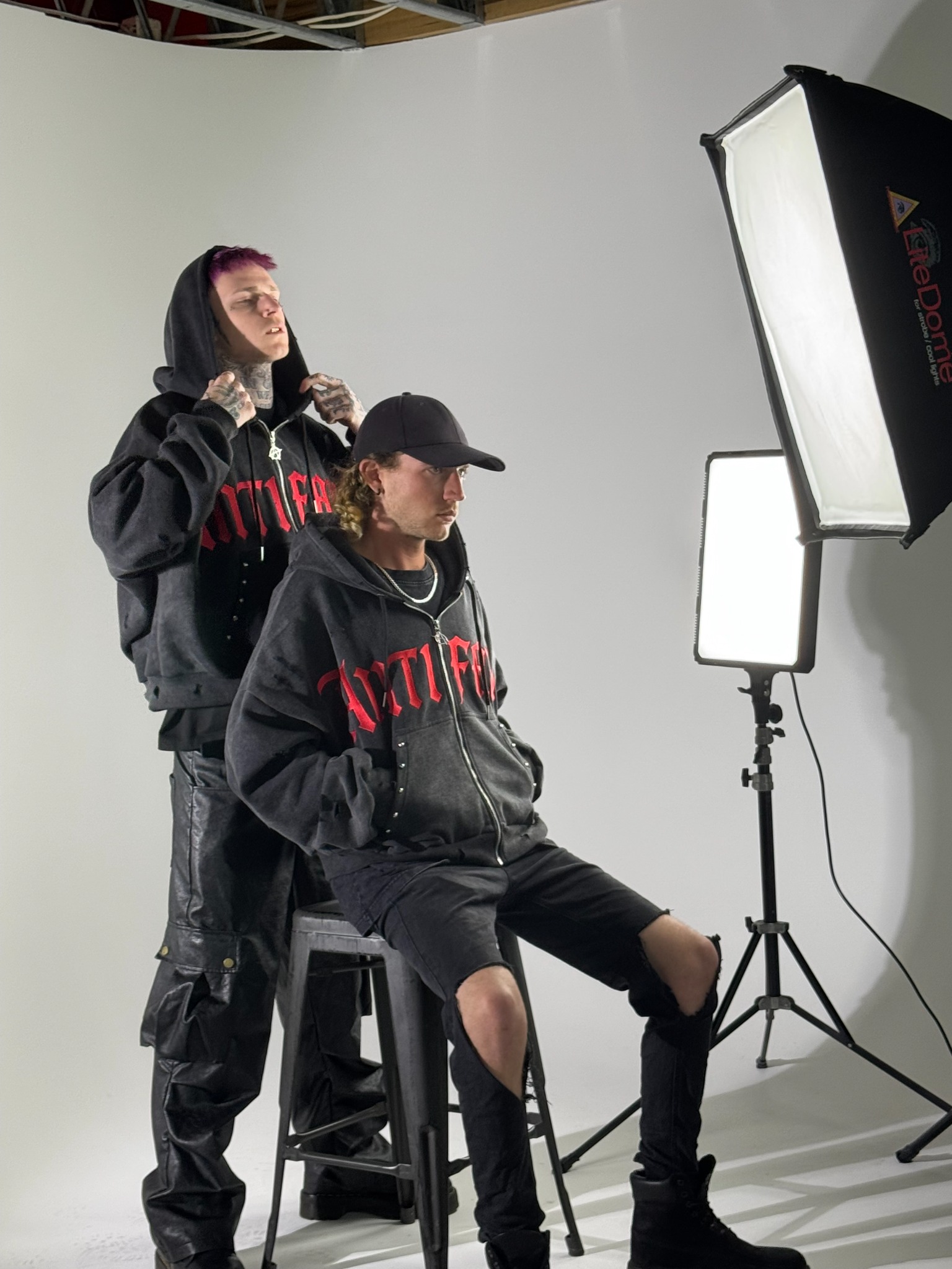 Wide BTS shot showing crew and gear in the cyclorama